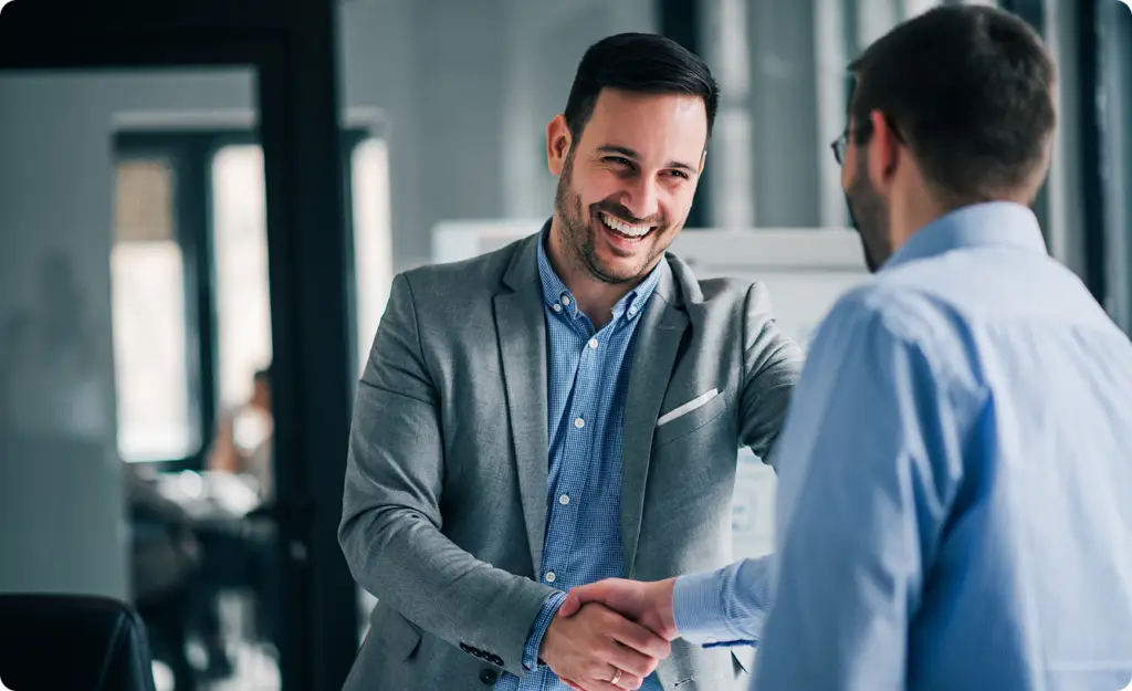 a man shaking hands with another man